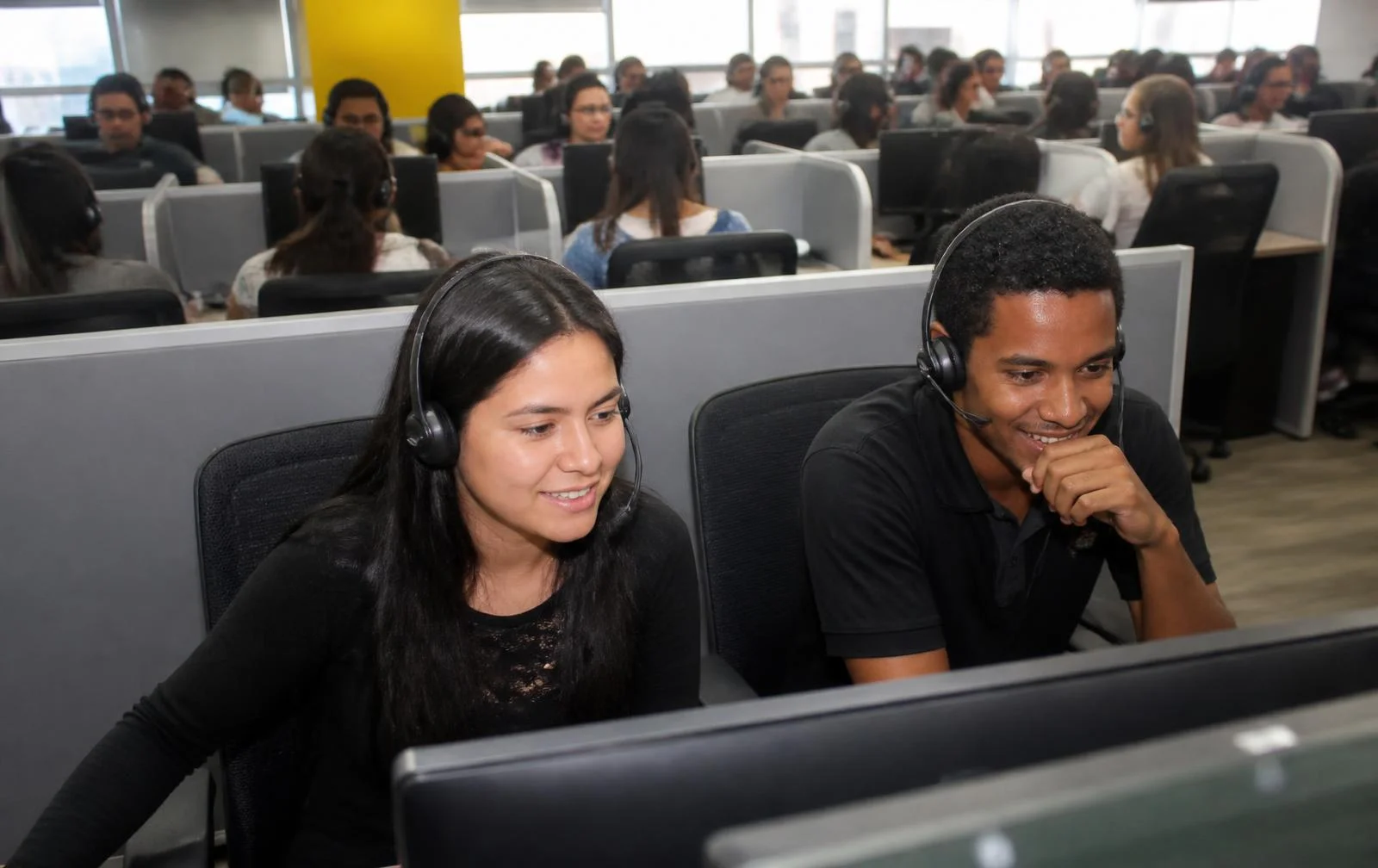Call center agents from Colombia working with headsets on a modern operations floor